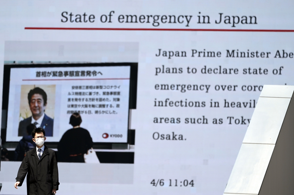 6일 일본 도쿄에서 한 남성이 아베 신조 일본 총리가 신종 코로나바이러스 감염증(코로나19)에 대한 긴급사태를 선포할 계획이라고 보도하는 화면 앞을 지나가고 있다. 아베 총리는 코로나19 관련 7일 도쿄도 등 7개 도도부현에 1개월 동안 '긴급 사태'를 선포할 것이라고 밝혔다. ⓒap