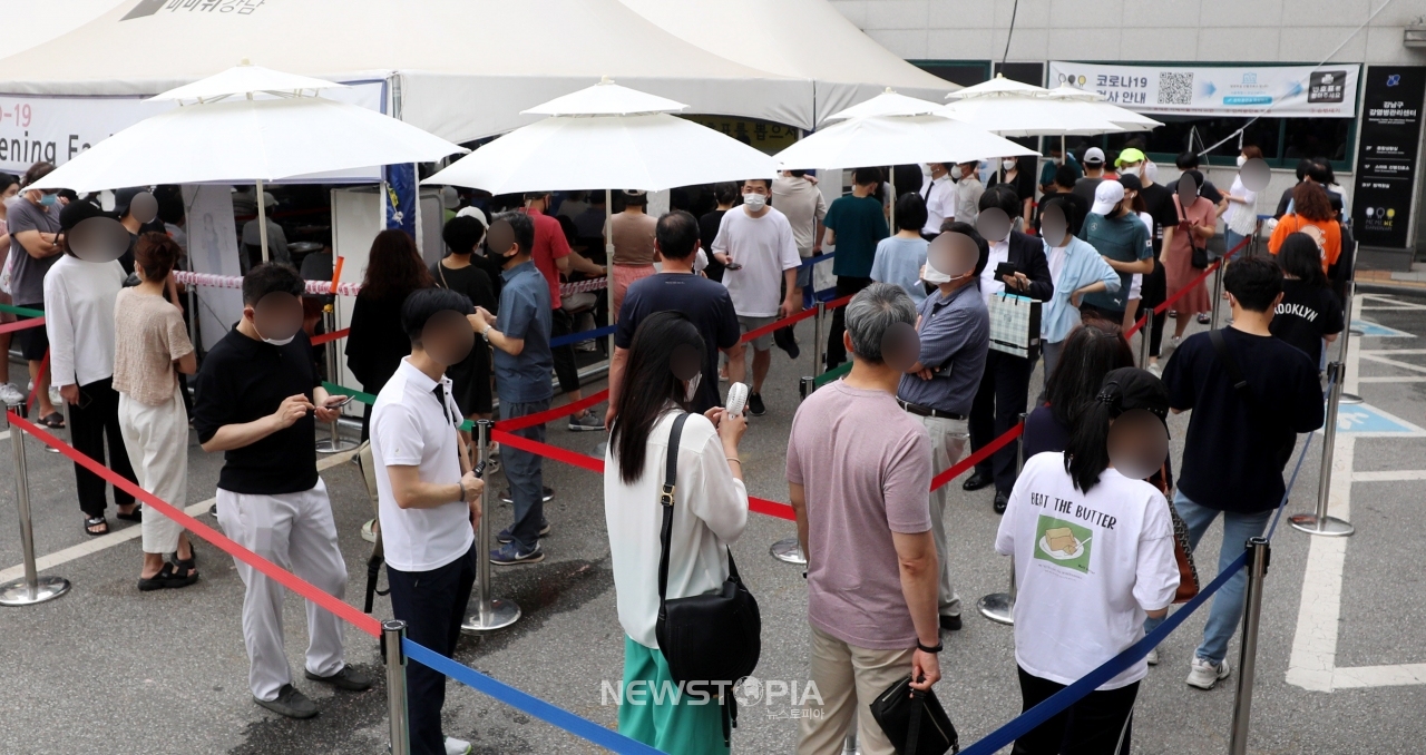 코로나 확진자수가 연일 1000명대를 넘어서고 있는 13일 오전 서울 강남구보건소 선별진료소에는 시민들이 코로나19 검사를 받기 위해 길게 줄지어 서 있다. ⓒ뉴시스