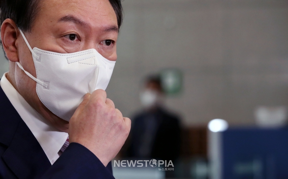 윤석열 대통령이 16일 서울 용산 대통령실 청사로 출근해 취재진 질문을 들으며 마스크를 고쳐쓰고 있다.ⓒ뉴시스